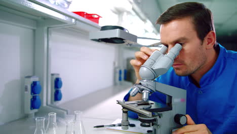 Scientist-microscope.-Man-scientist-doing-microscope-research-in-laboratory